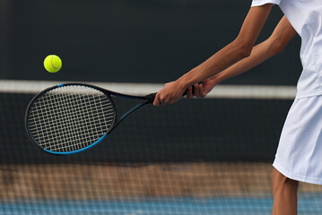 Estores personalizados esportes com sua foto Male tennis player hitting backhand by net on the tennis court