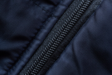 A close up shot of a black zipper on a black jacket