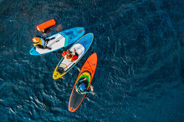 Stand up paddle surfing or SUP race competition. the competition has begun. many boards in the...