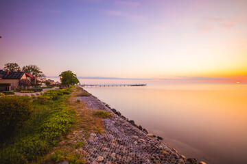 Amazing sunrise over the pier in Mechelinki. Baltic Sea