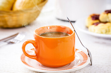 milk with coffee, traditional Brazilian breakfast drink, served hot with bread and toast