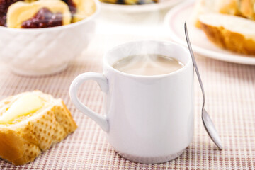 Obraz na płótnie Canvas milk with coffee, traditional Brazilian breakfast drink, served hot with bread and toast