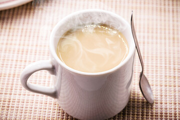 typical brazilian latte cup, or milk with coffee, drink served hot, steam and smoke coming out of the cup, for breakfast