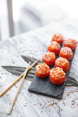 Sushi Set nigiri and sushi rolls on black stone plate board top view