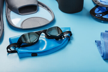 Sports equipment for swimming in the pool and open water on a blue background
