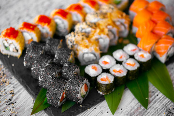 Sushi Set nigiri and sushi rolls on black stone plate board top view