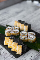 Sushi Set nigiri and sushi rolls on black stone plate board top view