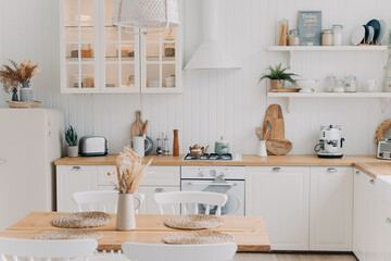 Scandinavian kitchen design. Modern dining room decoration. White luxurious interior and appliance.