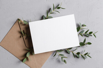 Wedding invitation stationery card mockup with eucalyptus twigs and envelope