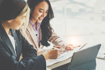 crop shot of Asian business professionals working together and discussing work sitting at a conference table in the office. Financial analysts analyze business financial reports