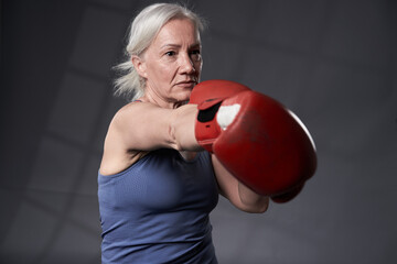 Senior woman taking boxing lessons