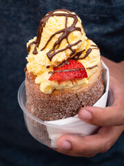 Trdelnik, also called trdlo or trozkol, a Czech Spit Cake with Vanilla Ice Cream, Chocoolate Sauce and Strawberry