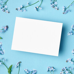 Wedding invitation or greeting card mockup with forget-me-not flowers