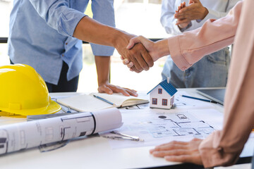 Architect and engineer construction workers shaking hands after successful collaboration. working...