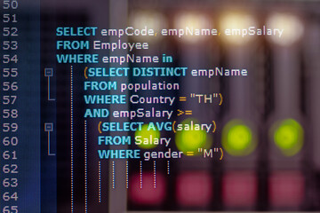 Close-up photo from a computer screen SQL (Structured Query Language) code and server room background. Example of SQL code to query data from a database.