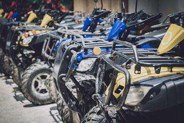 Fototapeta na wymiar View of row dirty ATVs quad bike