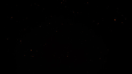 sparks like particles floating in air over black background