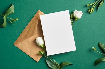 Invitation or greeting card mockup with white eustoma flowers on green