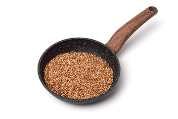 Dry buckwheat into the pan isolated on white background.
