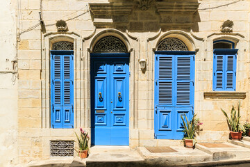 Details of mediterranean architecture. Blue doors and shutters with elegant lace