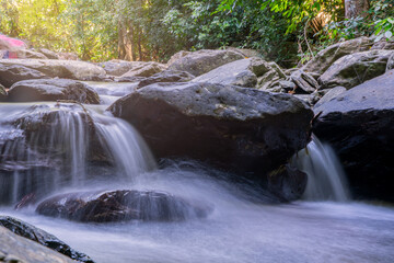 Fototapeta na wymiar beautiful waterfall in rainforest at National Park, Thailand