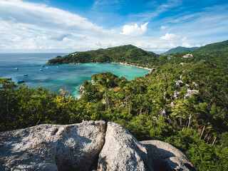 Scenic high angle view of Chalok Baan Kao Bay tropical white sand beach, clear turquoise sea with coral reef against blue sky. John Suwan Viewpoint, Koh Tao Island, Surat Thani, Thailand.