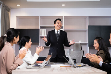 Group of business person applause and feeling happy for their success from online distance meeting in front of computer laptop. New normal for business and working.