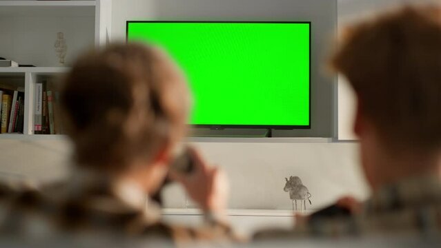 Video games tv chroma key set in living room. Unknown woman celebrating victory.