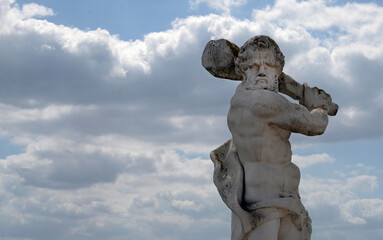 Statue menacingly raising a club to strike