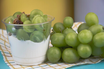 yoghurt in clear cup,topping with fresh grape,