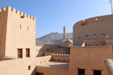 Nizwa, Oman. 21-01-2022. View on the Al Qala'a Mosque and the mountains in from fort Nizwa.