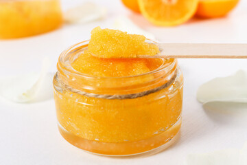 Cosmetic sugar scrub with citrus, orange spa product for exfoliating and cleansing the skin.