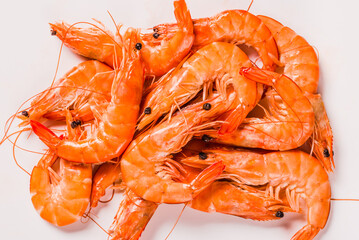 Shrimps on white background copy space. Cooked boiled red shrimps top view.