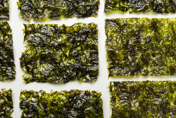 Tasty nori seaweed isolated on white.