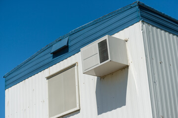 trailer with air conditioner and window in the sun