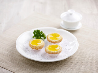 Baked Mini Egg Tart served in a dish isolated on mat side view on grey marble background