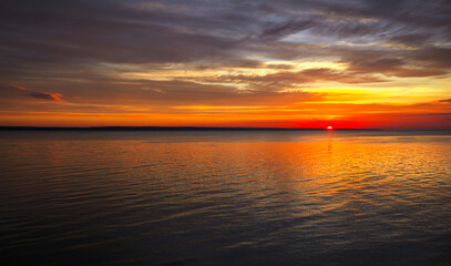 Obraz premium Dramatic sunset sky with clouds. Breathtaking sunset over the sea