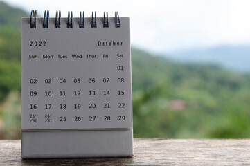 October month calendar with blurred nature background. Copy space and new month concept