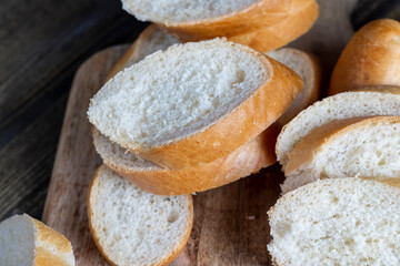 wheat baguette cut into pieces on a cutting board