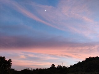 sunset and moon over the city 