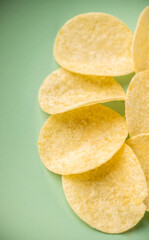 Salty grooved chips on ceramic plate. Selective focus. Shallow depth of field.