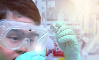 child use dropper in tube for education in learning laboratory and research with fun in chemical technology and biology like scientist