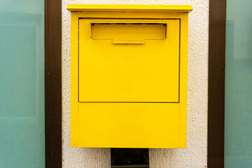 Close-up of yellow postbox. 