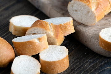 wheat baguette cut into pieces on a cutting board