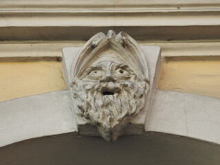 Funny mascaron made by a dauber on the ancient building in Slupsk, Poland