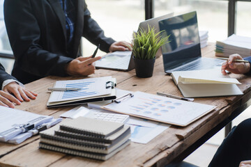 Team of business people working together in the meeting room office, teamwork background charts and...