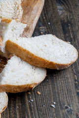 sliced loaf of bread on a cutting wooden board
