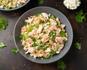 Salmon Couscous salad with feta cheese dressing and herbs. healthy food.