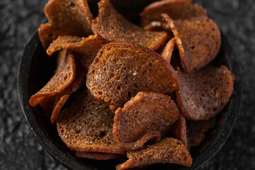 Garlic dark bread crisps, finger party food, beer snack