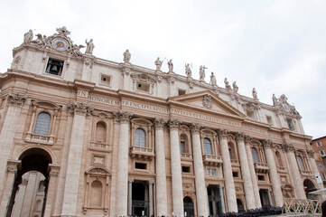 Fototapeta na wymiar Saint Peters Basilica facade exterior with colums and pediment in Vatican